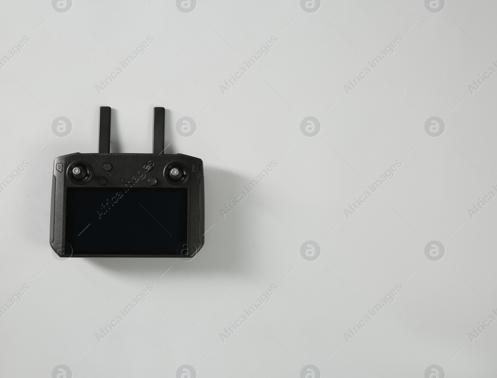 Photo of New modern drone controller on light background, top view