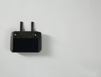 Photo of New modern drone controller on light background, top view