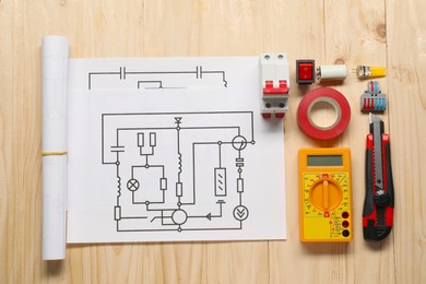 Flat lay composition with wiring diagrams and digital multimeter on wooden table