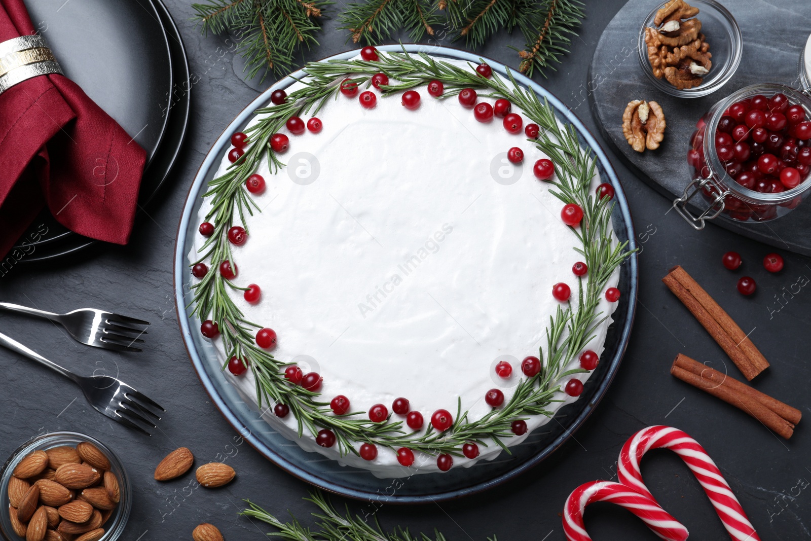 Photo of Flat lay composition with traditional Christmas cake and different ingredients on dark grey table
