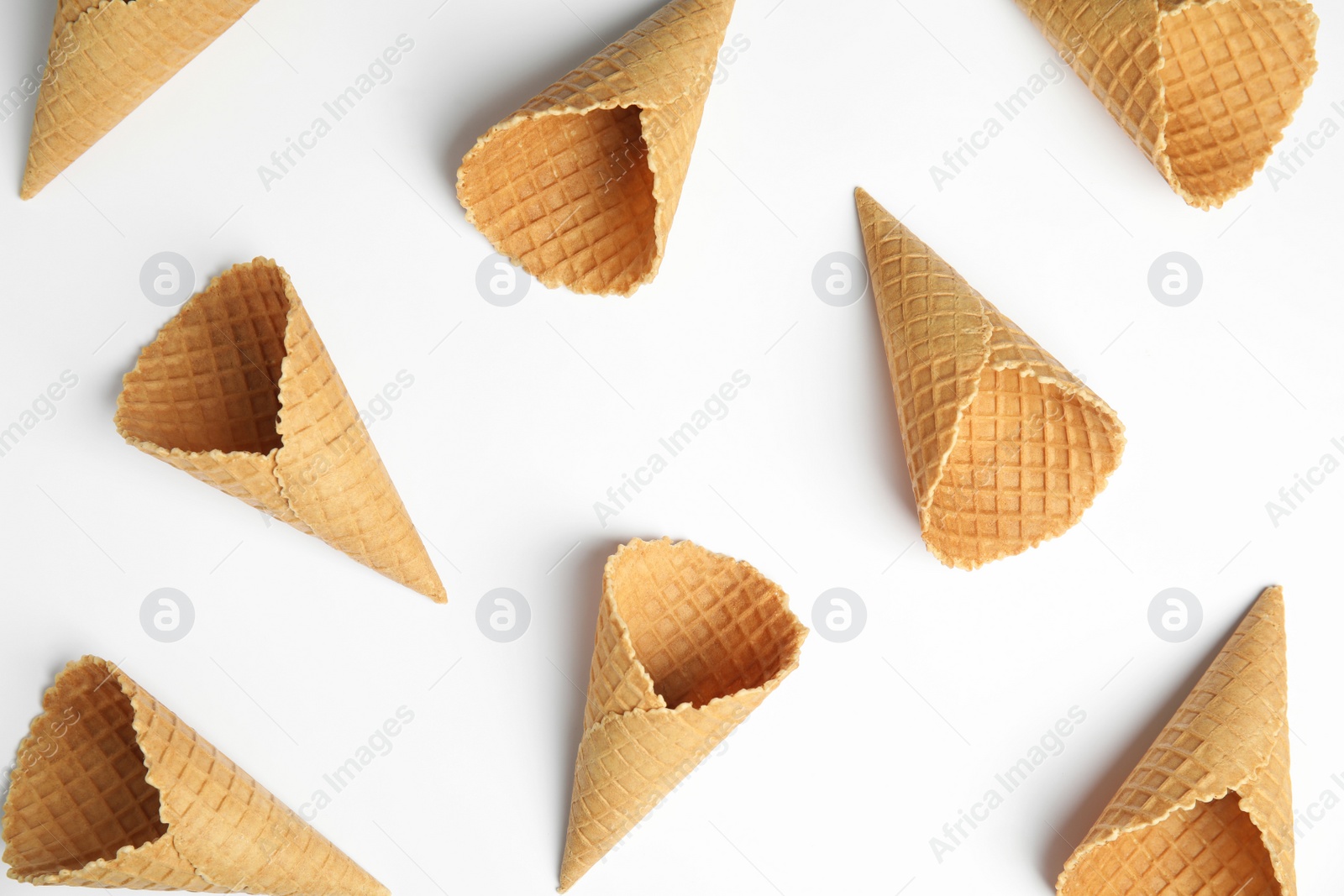 Photo of Waffle empty ice cream cones on white background, top view