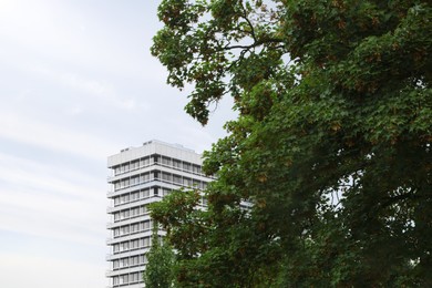 Photo of View of beautiful building, green trees and street lamp outdoors