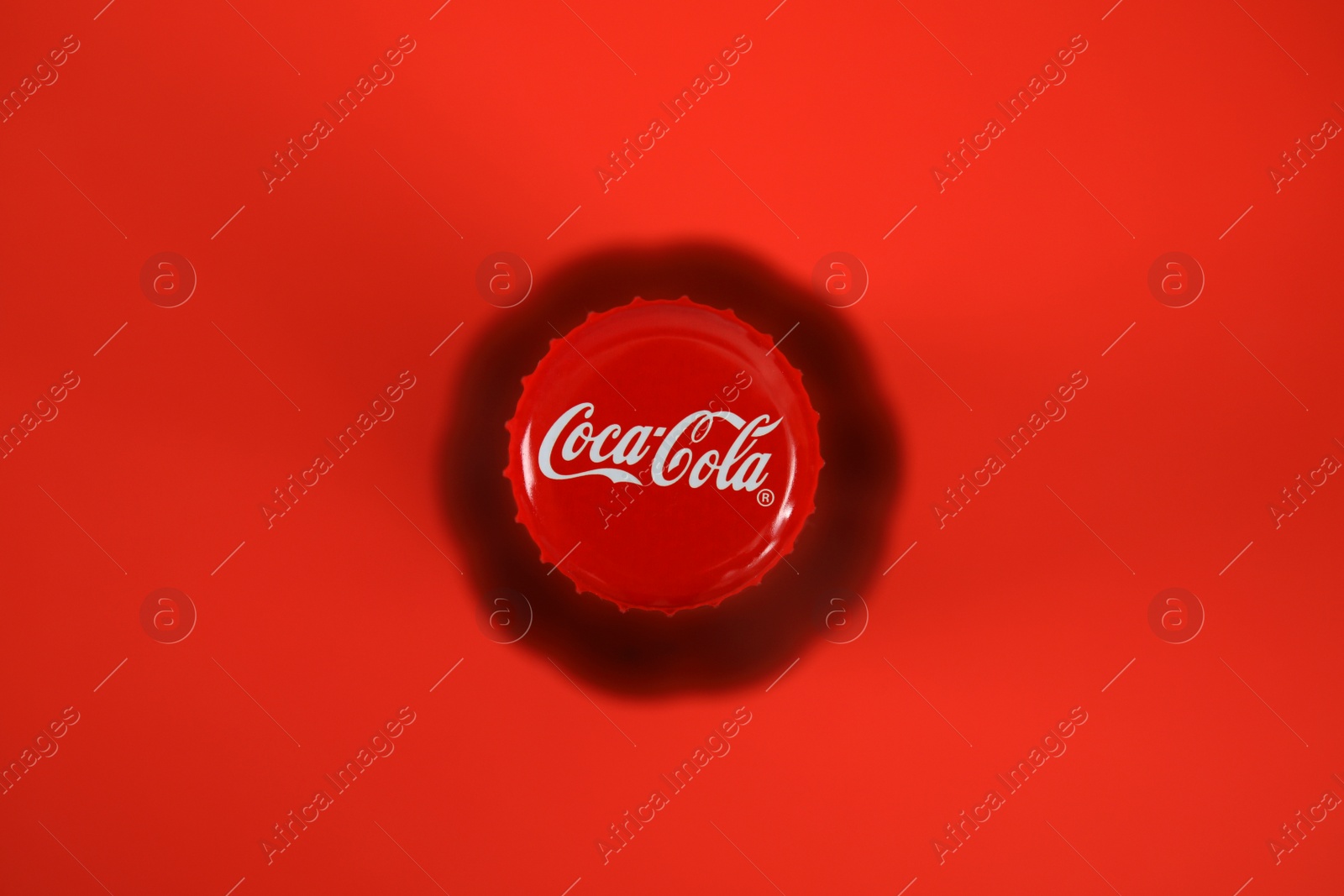 Photo of MYKOLAIV, UKRAINE - NOVEMBER 14, 2018: Bottle of Coca-Cola on color background, top view