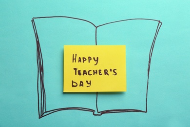 Paper with inscription HAPPY TEACHER'S DAY on color background