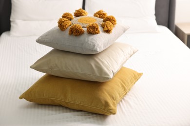 Photo of Stack of soft pillows and bedsheet on bed at home