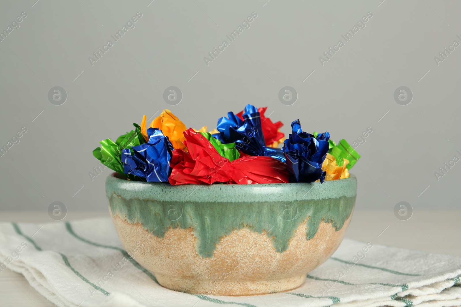 Photo of Candies in colorful wrappers on light table