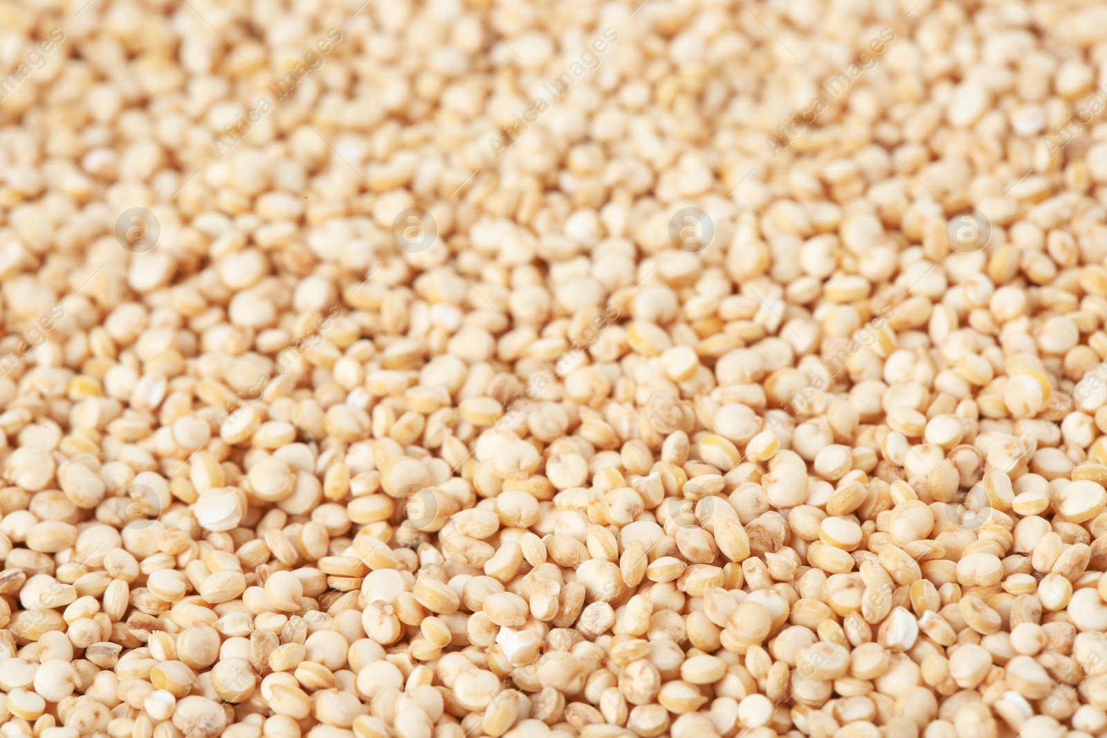 Photo of Raw white quinoa seeds as background, closeup