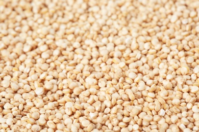 Raw white quinoa seeds as background, closeup