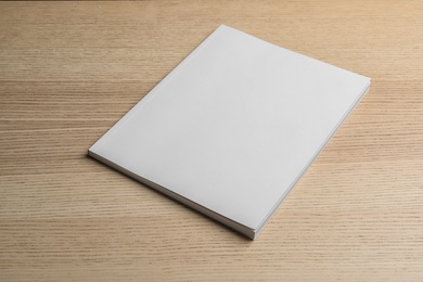 Brochure with blank cover on wooden background. Mock up for design