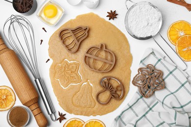 Photo of Flat lay composition with cookie cutters and dough on white table