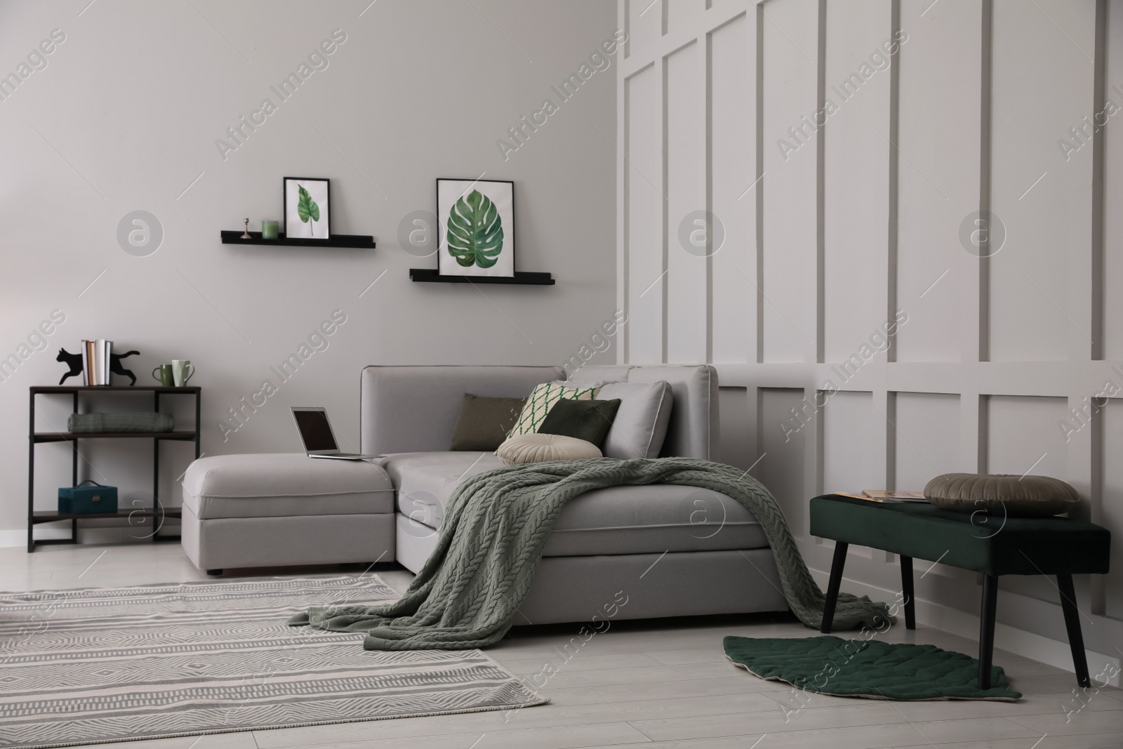 Photo of Living room with comfortable grey sofa and stylish interior elements