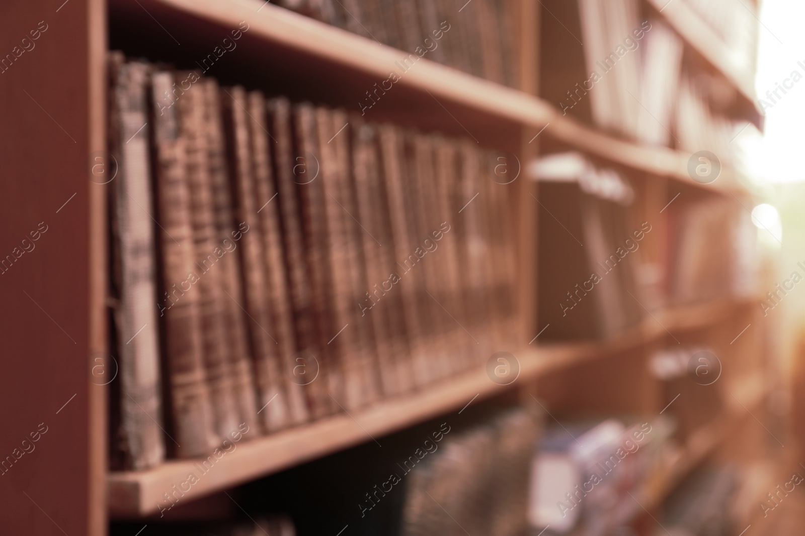 Photo of Blurred view of books on shelves in library