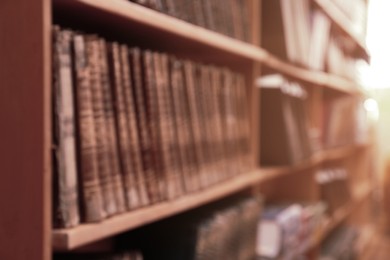 Blurred view of books on shelves in library