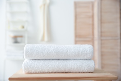 Stack of towels on table against blurred background