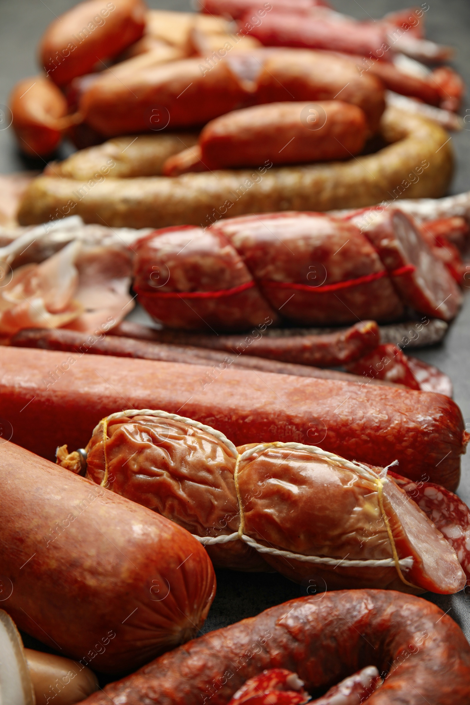 Photo of Different types of sausages on table, closeup