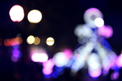 Blurred view of city street with festive lights at night. Bokeh effect