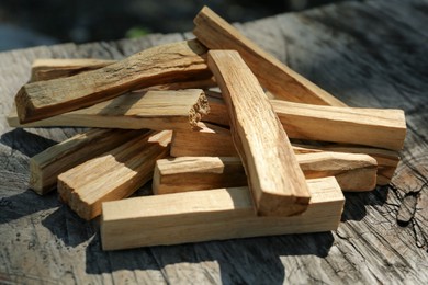 Photo of Palo santo sticks on wooden table, closeup