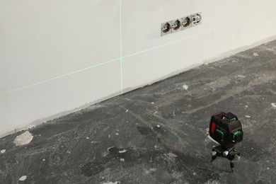 Laser level on floor near electrical sockets