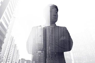 Image of Double exposure of businessman and cityscape with office buildings