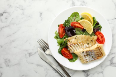 Photo of Tasty cod cooked served with salad on white marble table, flat lay. Space for text