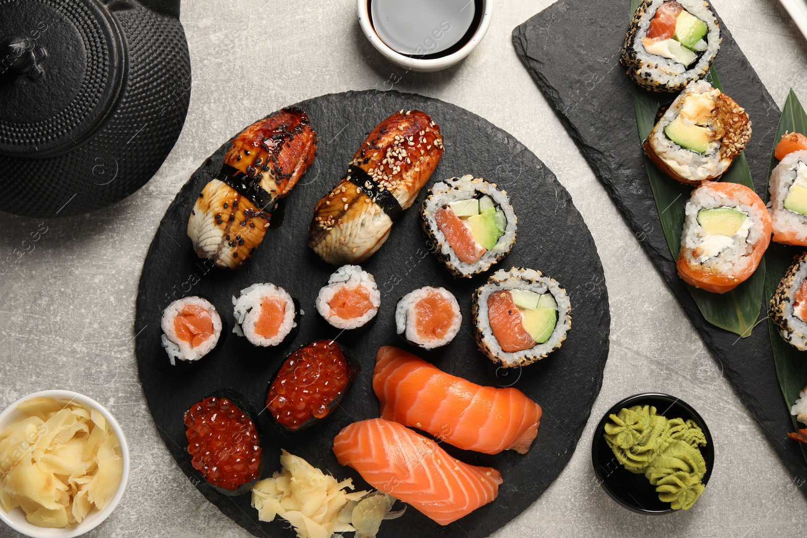 Photo of Flat lay composition with delicious sushi rolls on light grey table