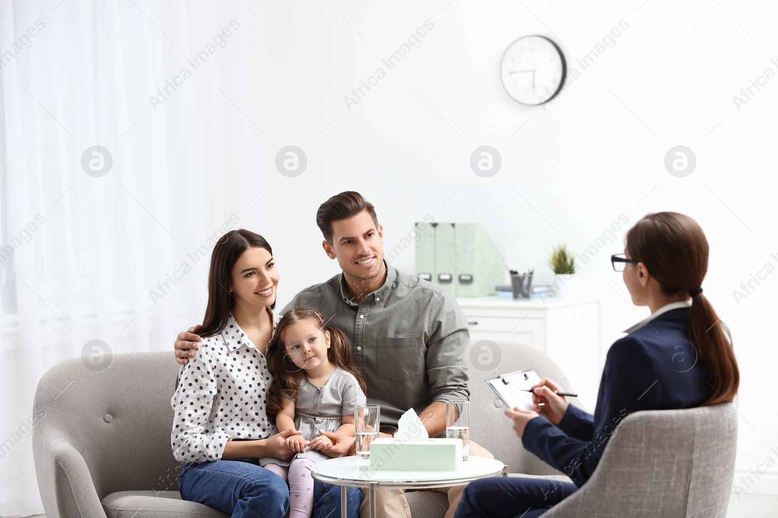 Photo of Professional psychologist working with family in office