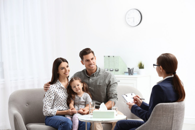 Photo of Professional psychologist working with family in office