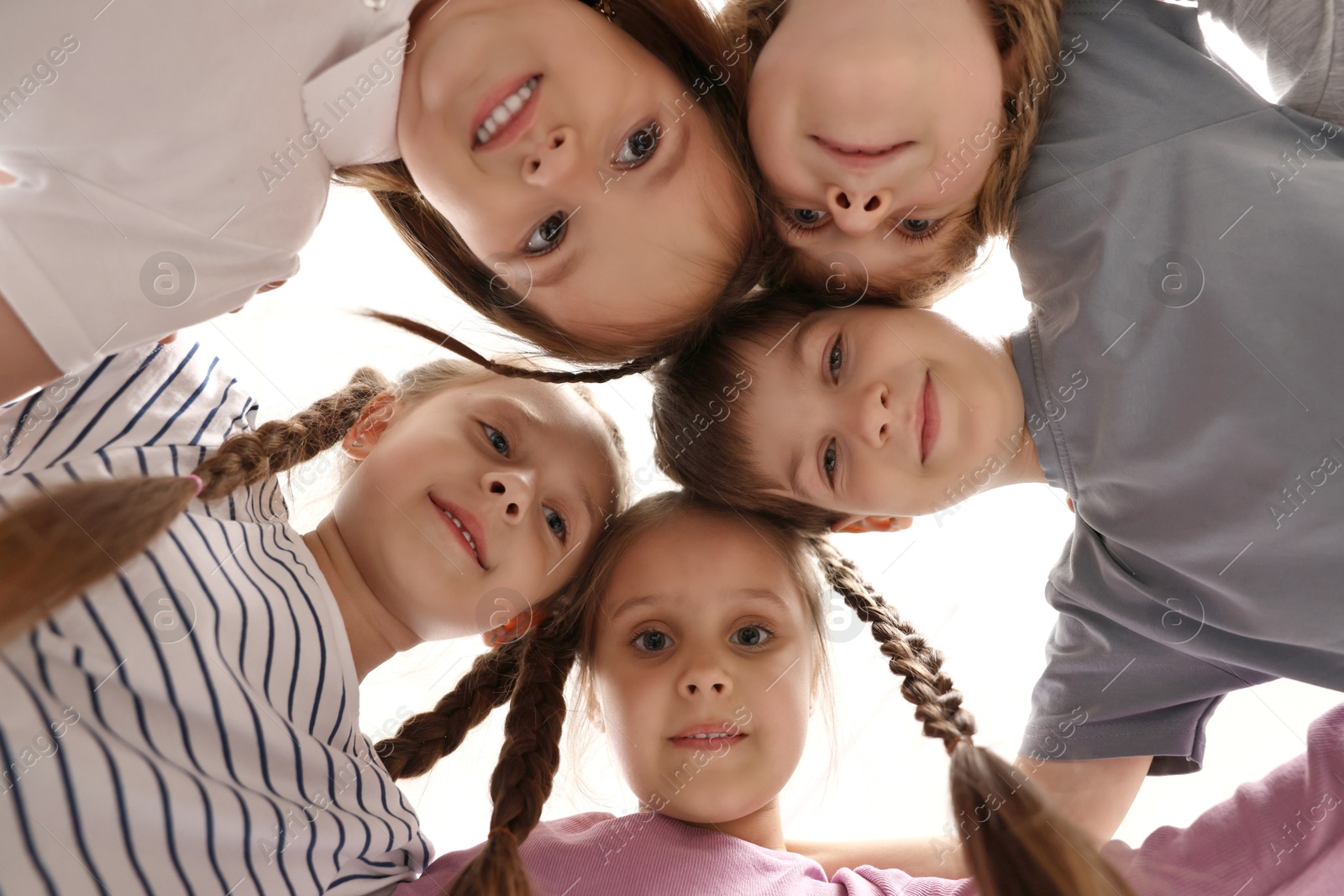 Photo of Group of cute little children indoors, bottom view