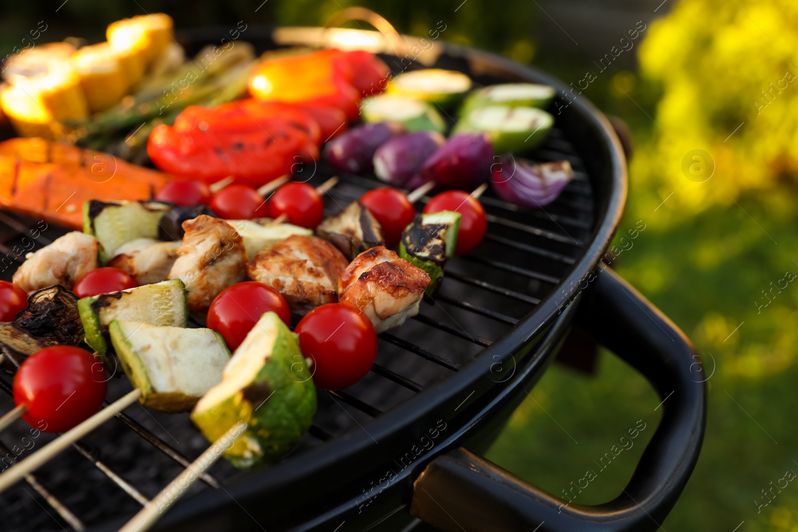 Photo of Delicious grilled vegetables on barbecue grill outdoors, closeup