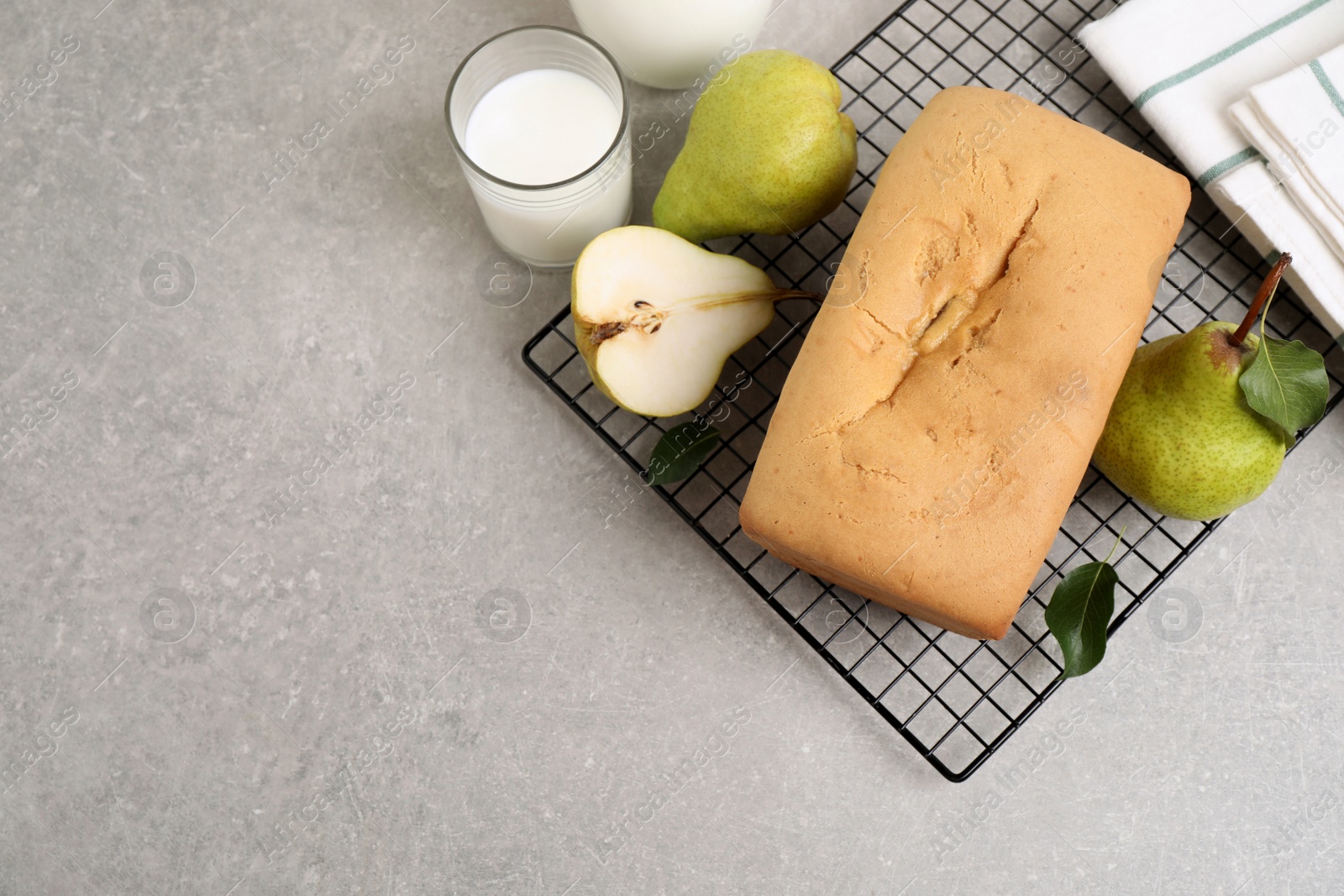 Photo of Flat lay composition with pear bread on light grey table, space for text. Homemade cake