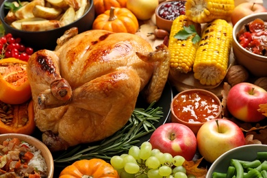 Photo of Traditional Thanksgiving day feast with delicious cooked turkey and other seasonal dishes as background, closeup