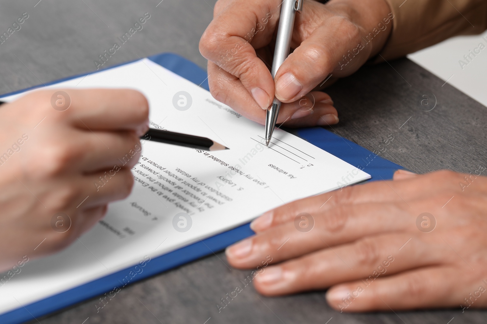 Photo of Manager showing client where she must to mark signature at dark table, closeup