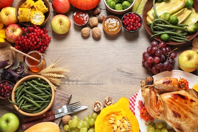Photo of Frame made of turkey, autumn vegetables and fruits on wooden background, flat lay. Happy Thanksgiving day