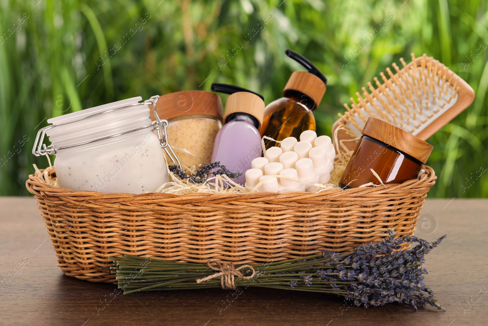 Photo of Spa gift set with different products on wooden table against blurred background