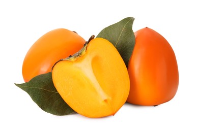 Photo of Whole and cut delicious ripe juicy persimmons on white background