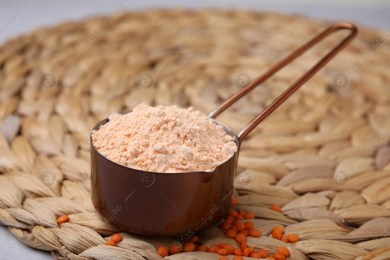 Photo of Organic lentil flour on wicker mat, closeup