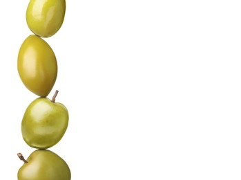 Stack of whole green olives on white background