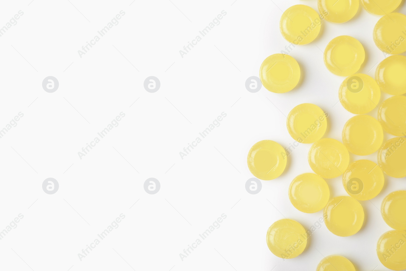 Photo of Color cough drops on white background. Top view with space for text