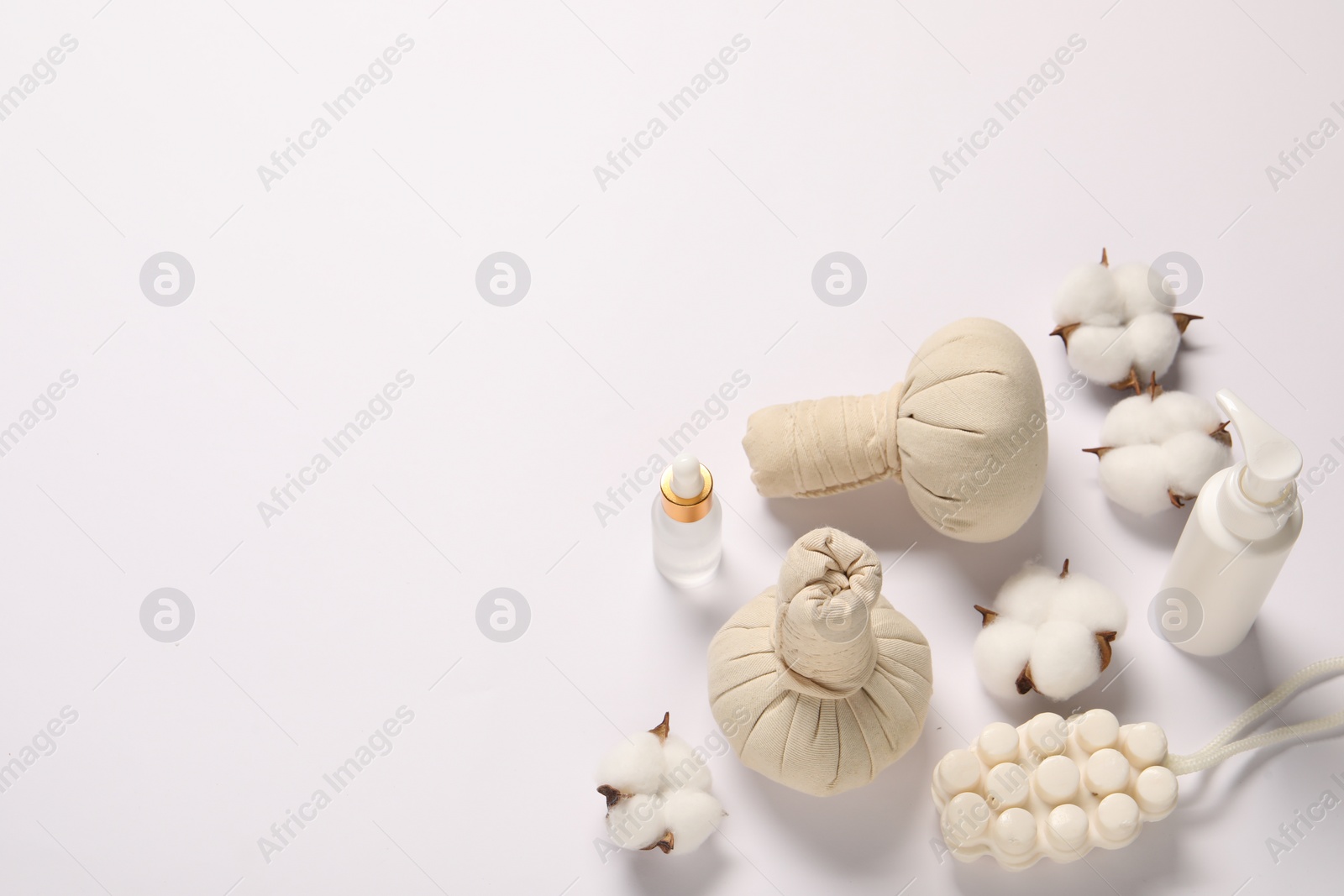 Photo of Bath accessories. Different personal care products and cotton flowers on white background, above view with space for text