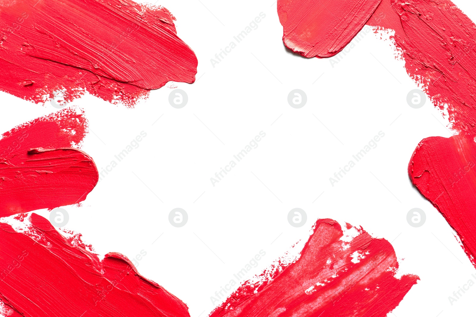 Photo of Red lipstick smears on white background, top view. Space for text