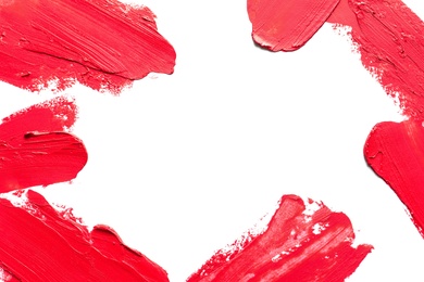 Red lipstick smears on white background, top view. Space for text