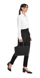 Photo of Happy businesswoman with bag walking on white background