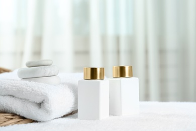 Composition with cosmetic products on white towel indoors, space for text. Spa therapy