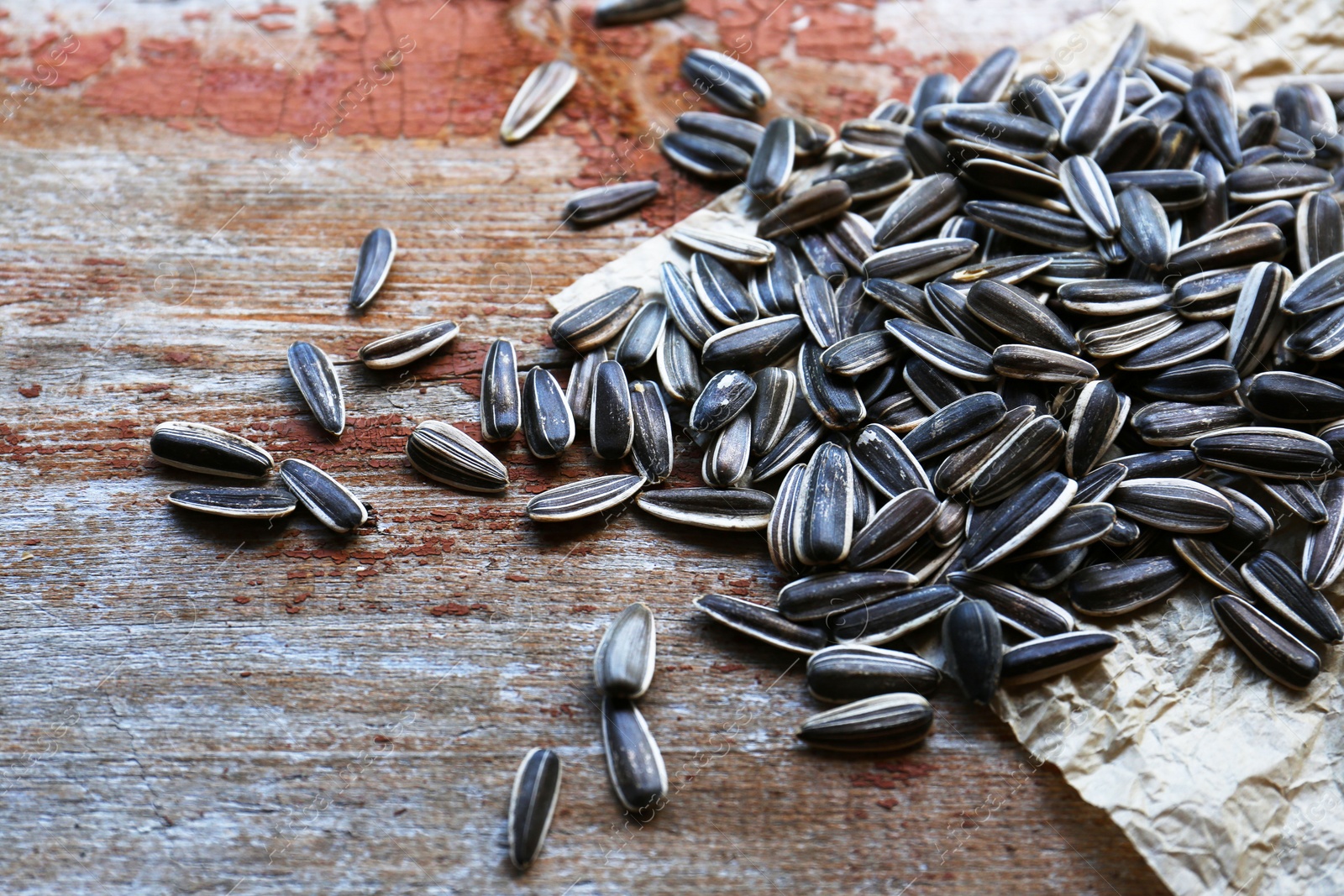 Photo of Pile of sunflower seeds on wooden table