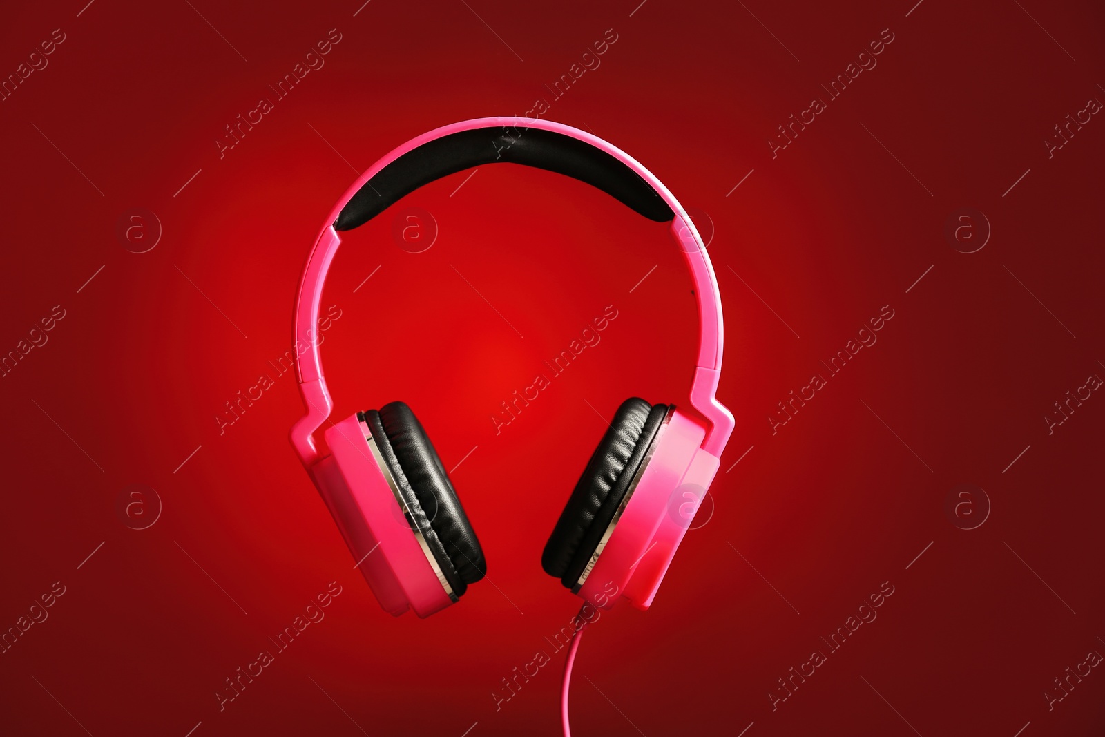 Photo of Stylish headphones with pads on color background