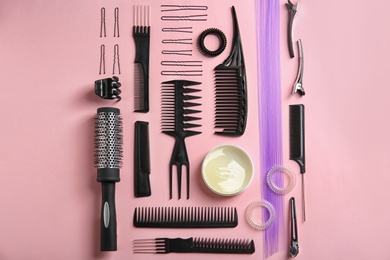 Photo of Flat lay composition with hair salon equipment on color background