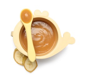 Delicious baby food in bowl, spoon and cut banana isolated on white, top view
