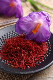 Dried saffron and crocus flowers on table, closeup