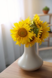 Bouquet of beautiful sunflowers on table indoors