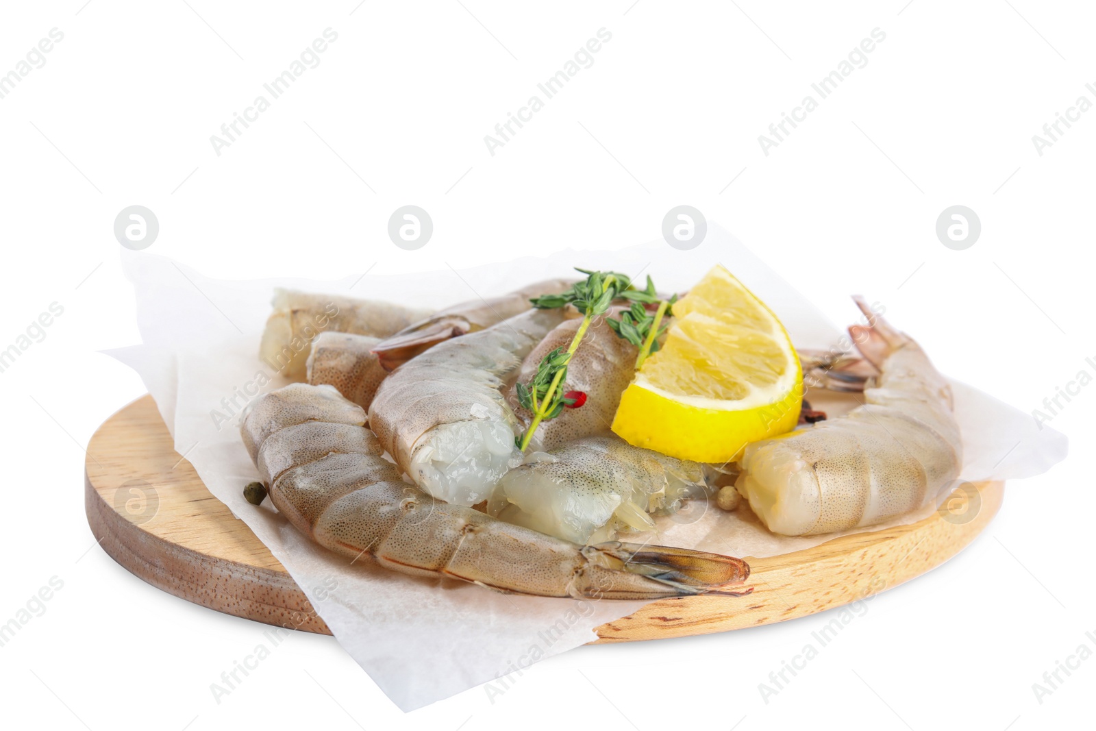 Photo of Wooden board with raw shrimps, lemon and thyme isolated on white